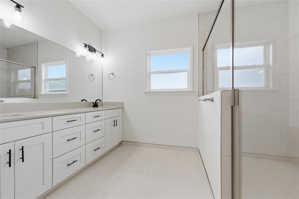 6735 Southwest 10th Lane Gainesville, FL 32607 - Photo 17 of 24 a spacious bathroom with 2 sink tub and a mirror