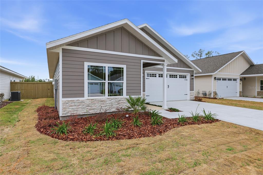 6735 Southwest 10th Lane Gainesville, FL 32607 - Photo 24 of 24 a front view of a house with a yard and garage