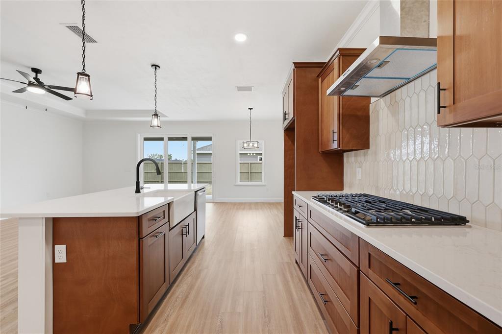 6735 Southwest 10th Lane Gainesville, FL 32607 - Photo 3 of 24 a kitchen with stainless steel appliances granite countertop a sink stove and refrigerator