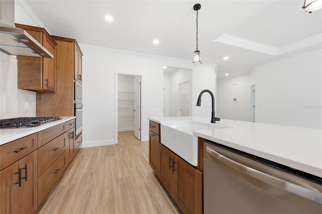 6735 Southwest 10th Lane Gainesville, FL 32607 - Photo 4 of 24 a kitchen with sink a stove and cabinets