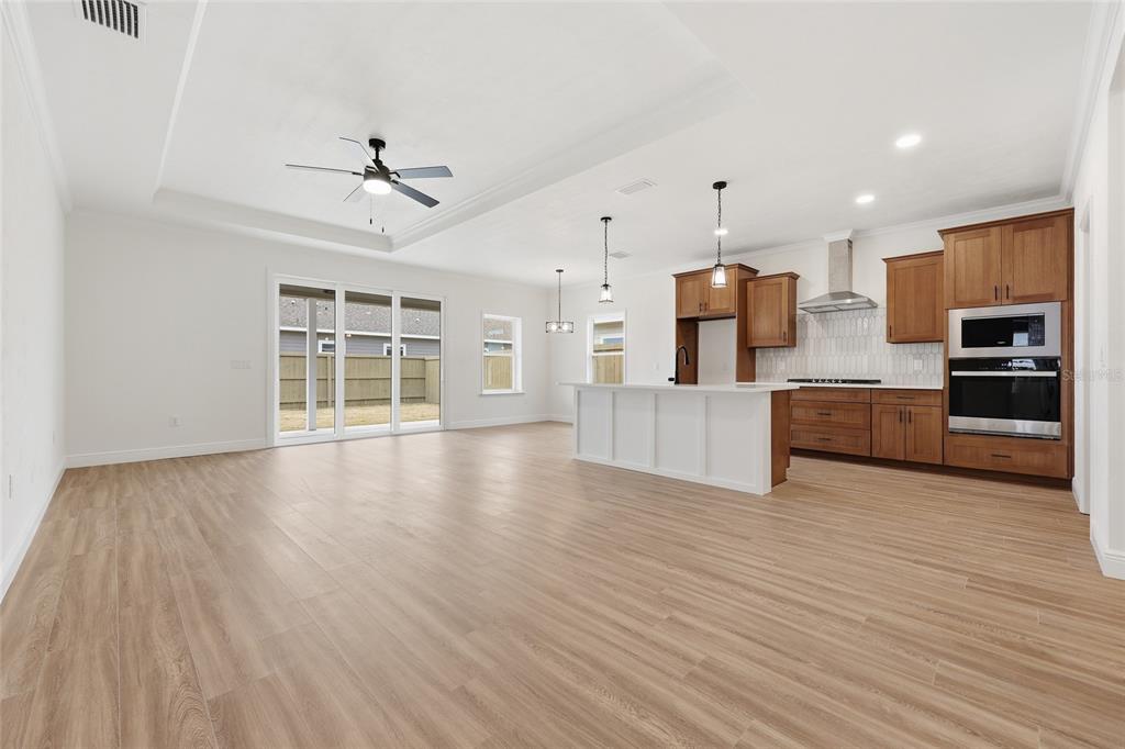 6735 Southwest 10th Lane Gainesville, FL 32607 - Photo 7 of 24 a view of a kitchen with a sink and dishwasher a refrigerator with wooden floor