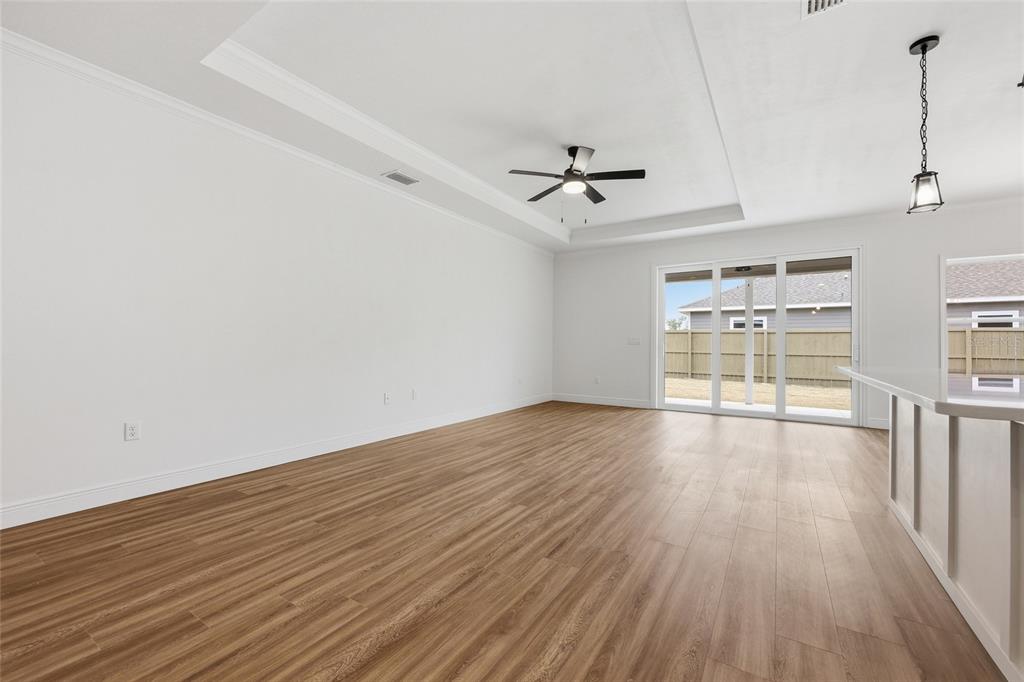 6735 Southwest 10th Lane Gainesville, FL 32607 - Photo 8 of 24 a view of empty room with wooden floor and fan