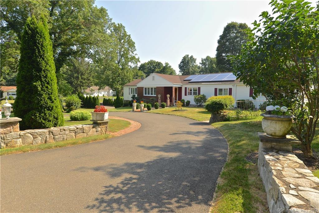 411 Fairlea Road Orange, CT 06477 - Photo 1 of 1 a view of a house with a yard patio and sitting area