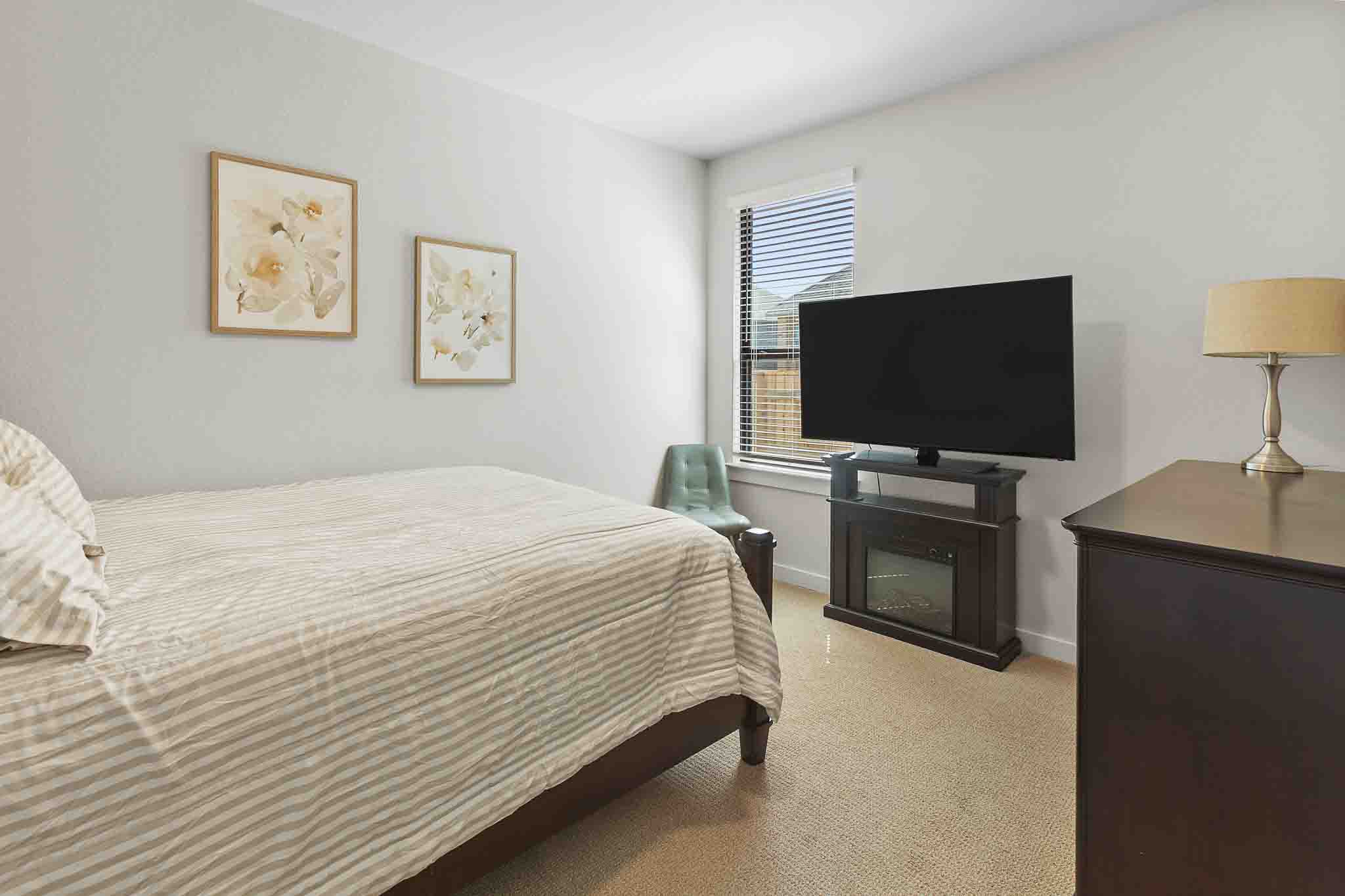 220 Basket Flower Loop Kyle, TX 78640 - Photo 30 of 40 A well-lit room offers cozy comfort and ample space for repose.