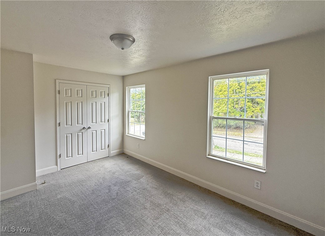 247 Reed Avenue Campbell, OH 44405 - Photo 16 of 41 Unfurnished bedroom featuring a textured ceiling, carpet flooring, and a closet