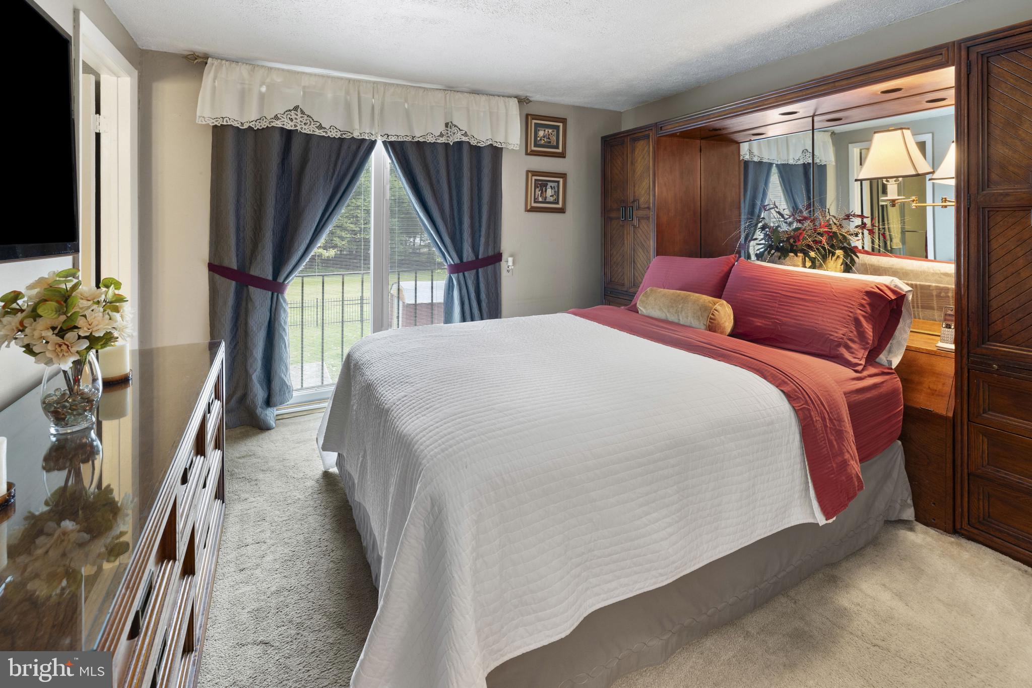 4105 Hanwell Road Randallstown, MD 21133 - Photo 18 of 37 a bedroom with a bed a flat screen tv and a large window