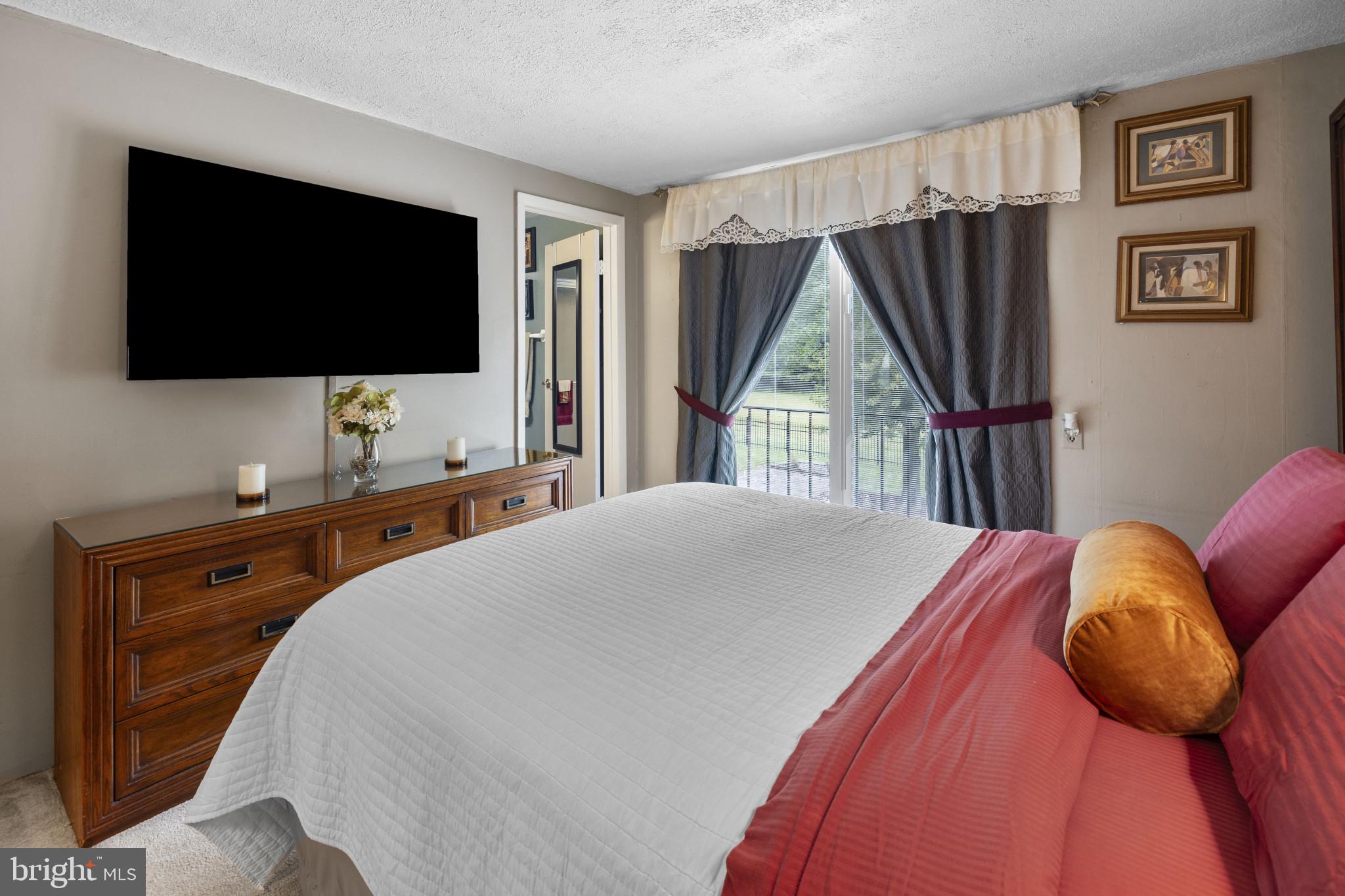 4105 Hanwell Road Randallstown, MD 21133 - Photo 19 of 37 a bedroom with a bed and a flat screen tv