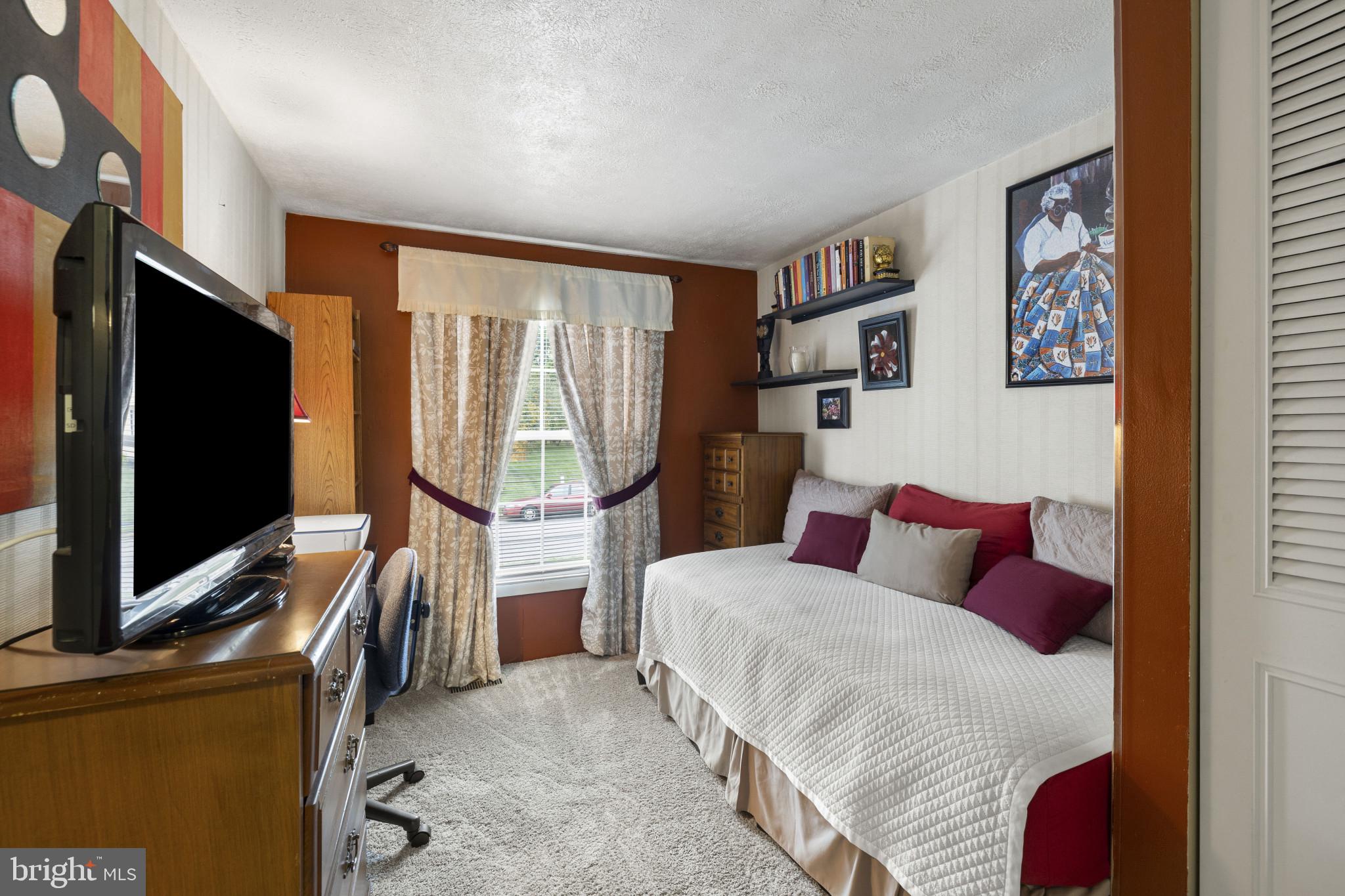 4105 Hanwell Road Randallstown, MD 21133 - Photo 21 of 37 a bedroom with a bed and a flat screen tv