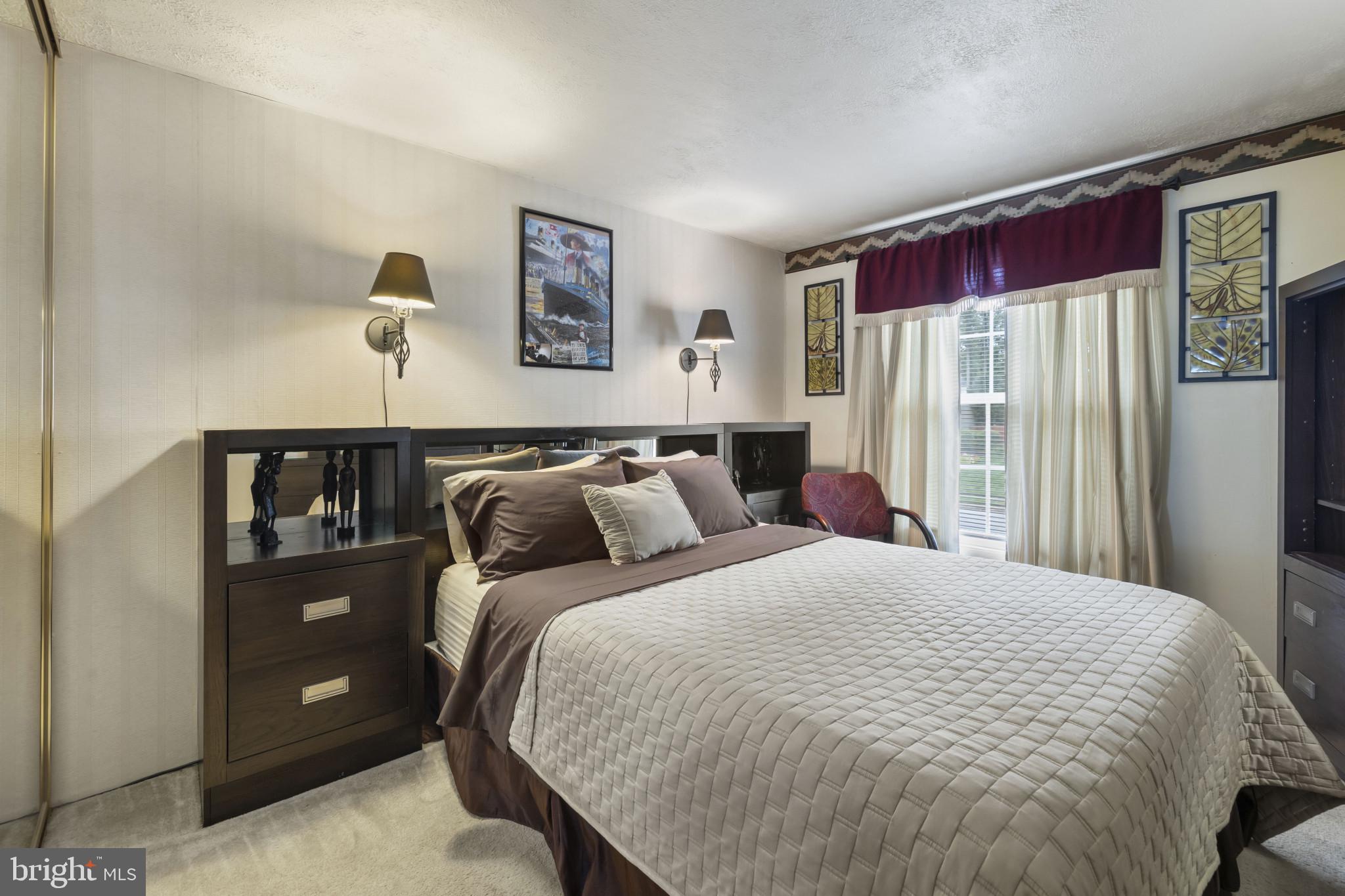 4105 Hanwell Road Randallstown, MD 21133 - Photo 24 of 37 a bed sitting in a bedroom next to a window