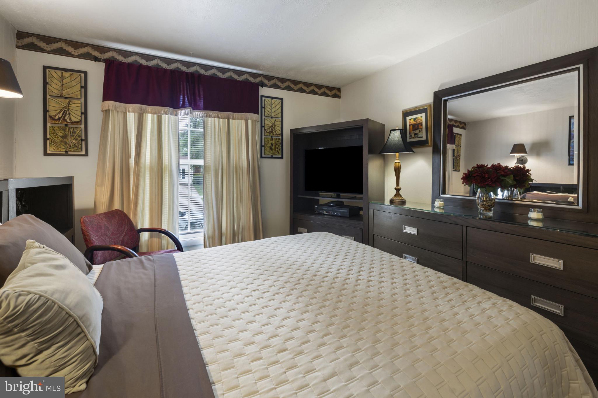 4105 Hanwell Road Randallstown, MD 21133 - Photo 25 of 37 a bedroom with a bed and a flat screen tv