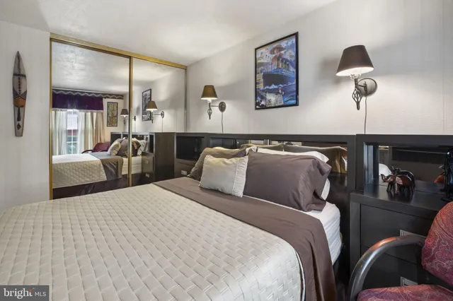 a bedroom with bed and cabinets