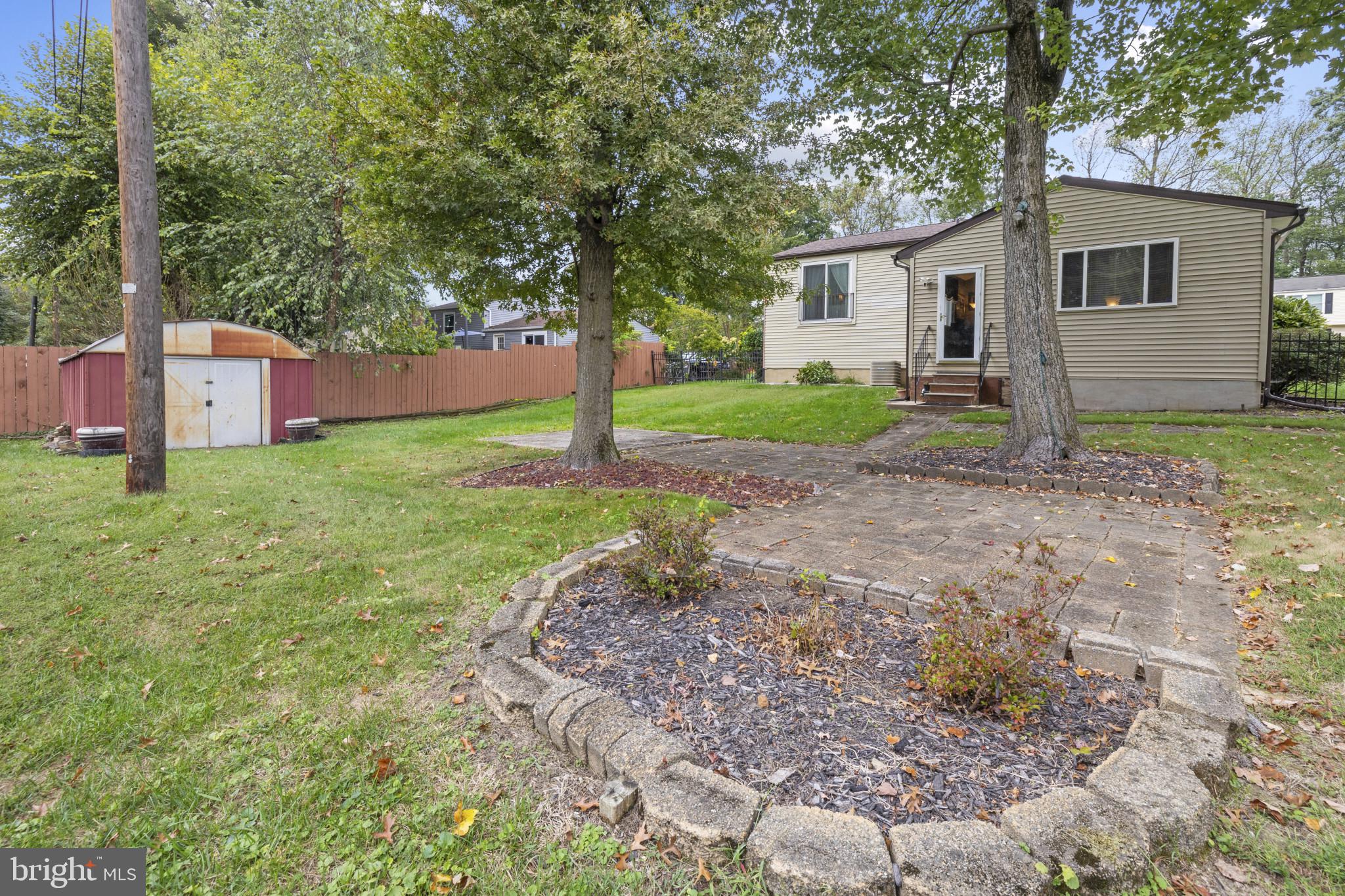 4105 Hanwell Road Randallstown, MD 21133 - Photo 35 of 37 a backyard of a house with plants and large tree