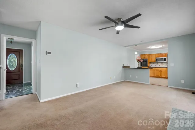 a view of a livingroom with a ceiling fan & a ceiling fan