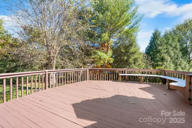 a view of house with a deck and furniture
