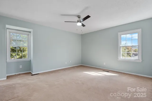 a view of backyard of house and green space