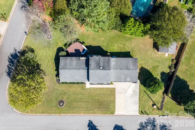 an aerial view of a house with a yard