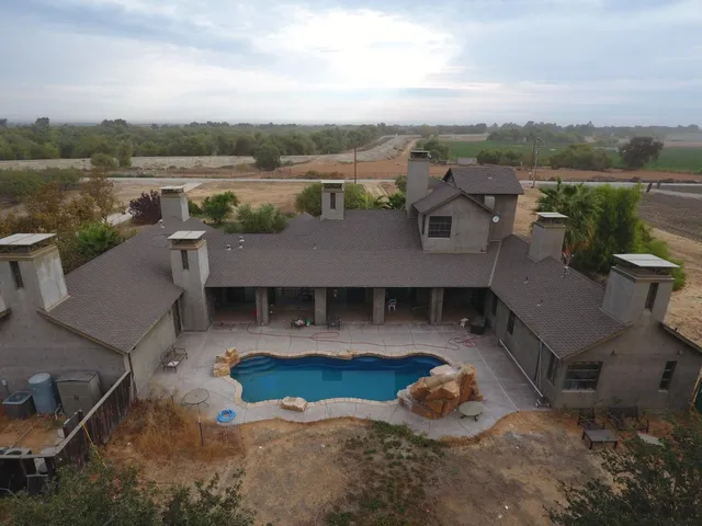 an aerial view of a house with yard
