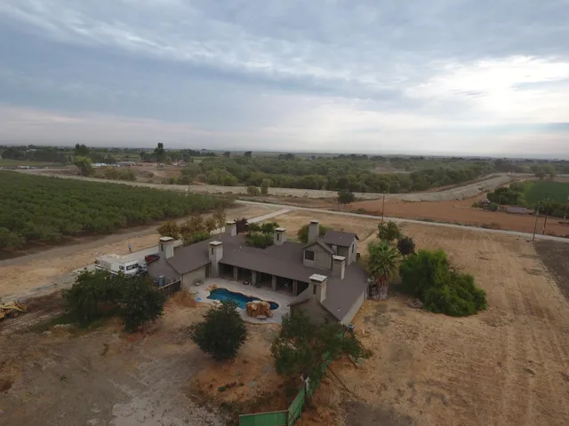 an aerial view of a house with a lake view