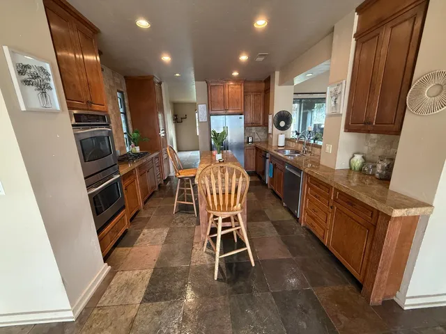 a kitchen with granite countertop lots of counter top space appliances and furniture