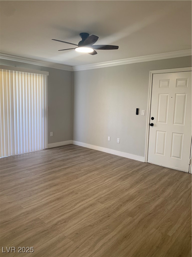 8101 West Flamingo Road, Unit 1102 Las Vegas, NV 89147 - Photo 13 of 54 Living room featuring a ceiling fan, ornamental molding, and wood finished floors