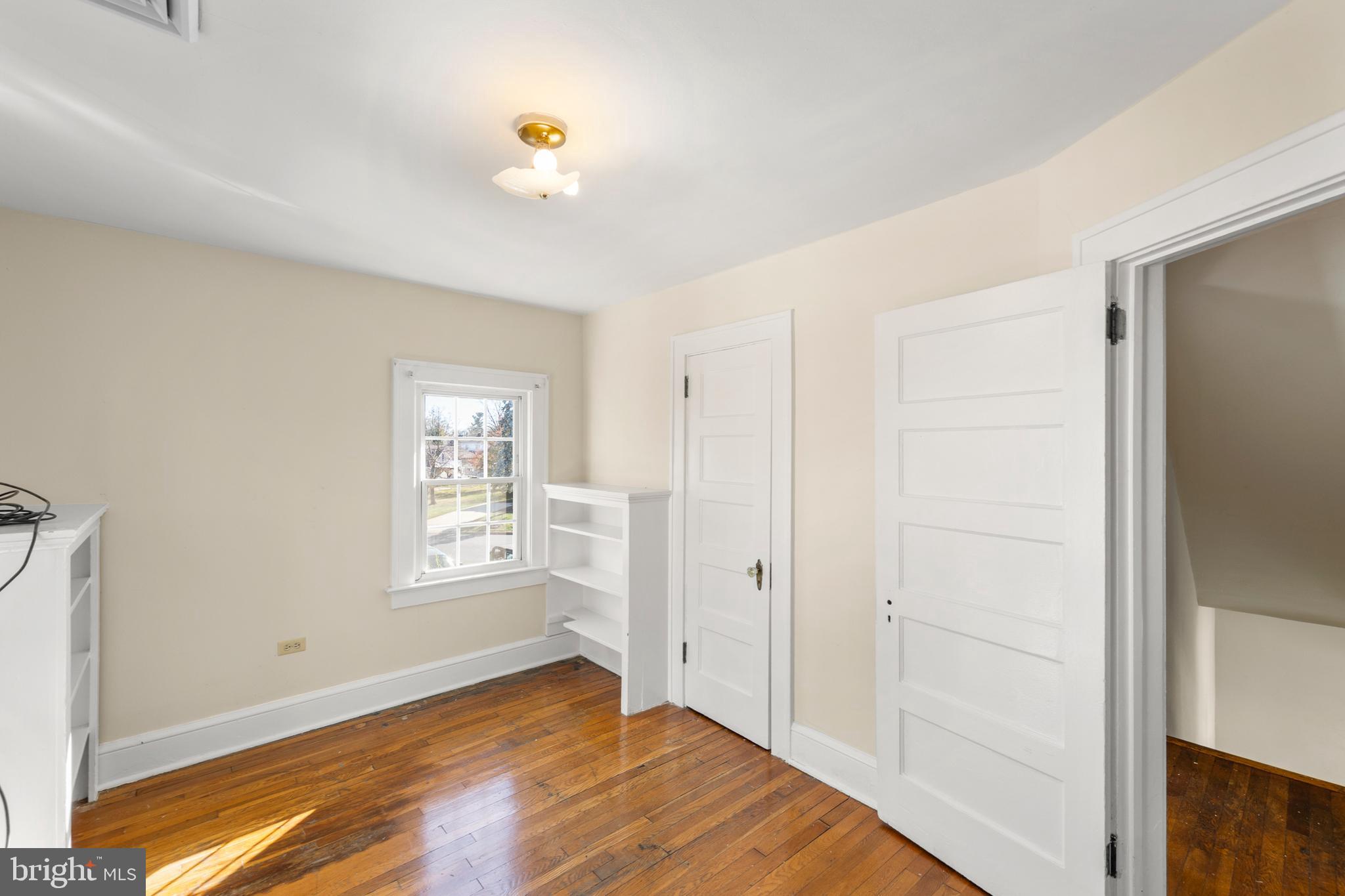675 Berryville Avenue Winchester, VA 22601 - Photo 20 of 32 a view of empty room with window and wooden floor