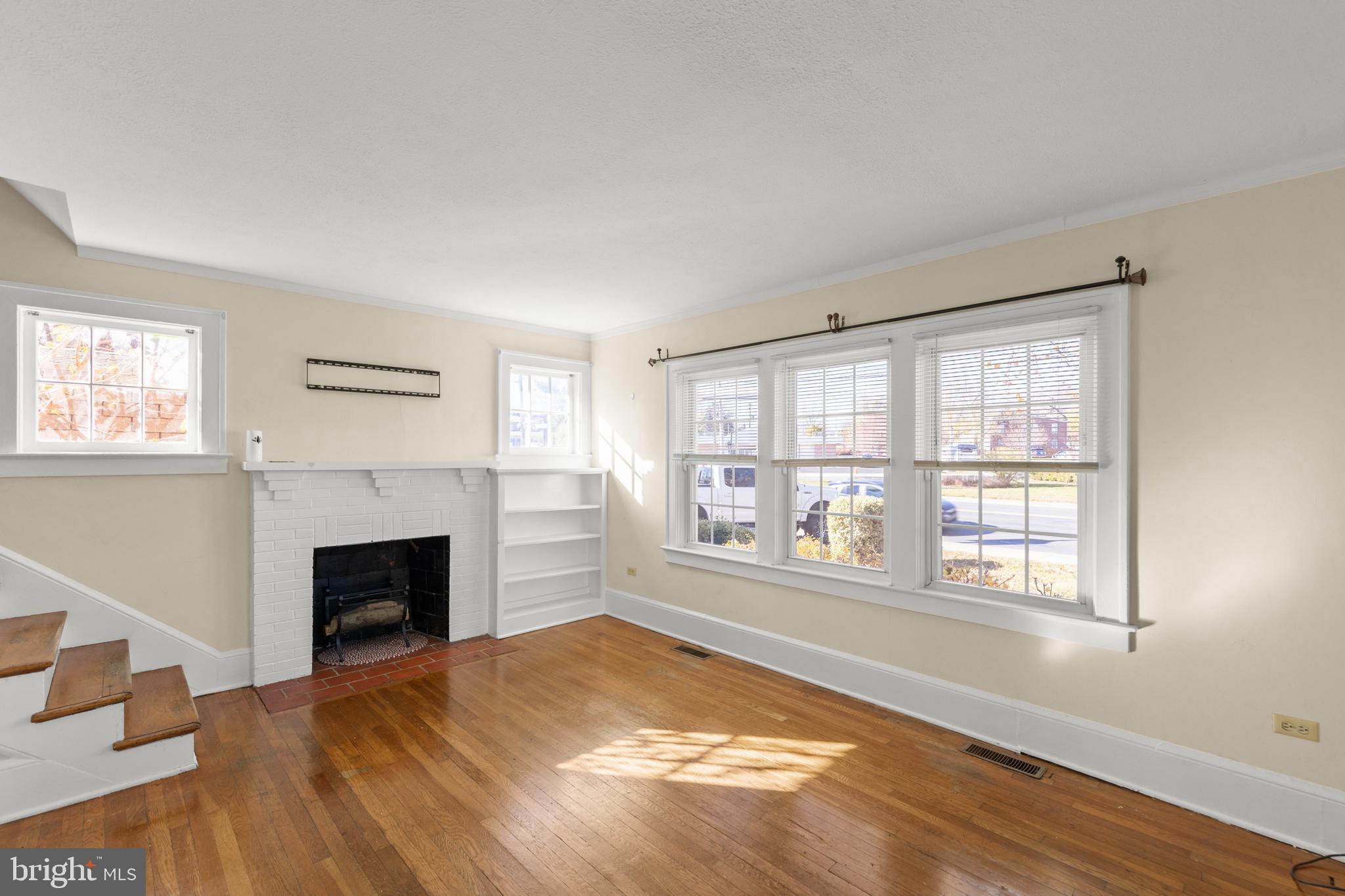 675 Berryville Avenue Winchester, VA 22601 - Photo 5 of 32 a view of empty room with fireplace and wooden floor