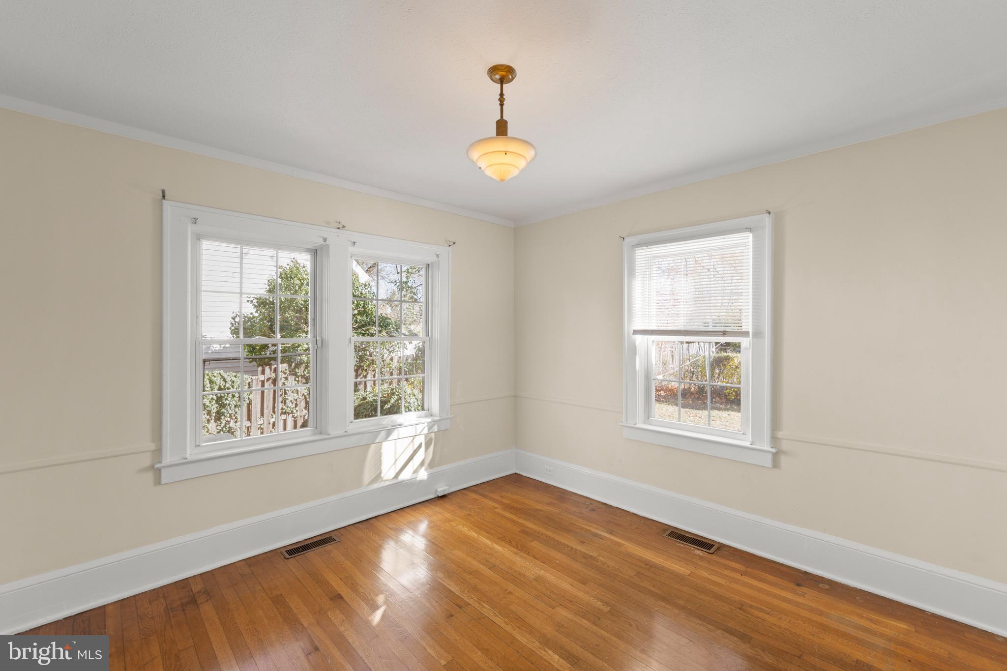 675 Berryville Avenue Winchester, VA 22601 - Photo 6 of 32 a view of an empty room with wooden floor and a window
