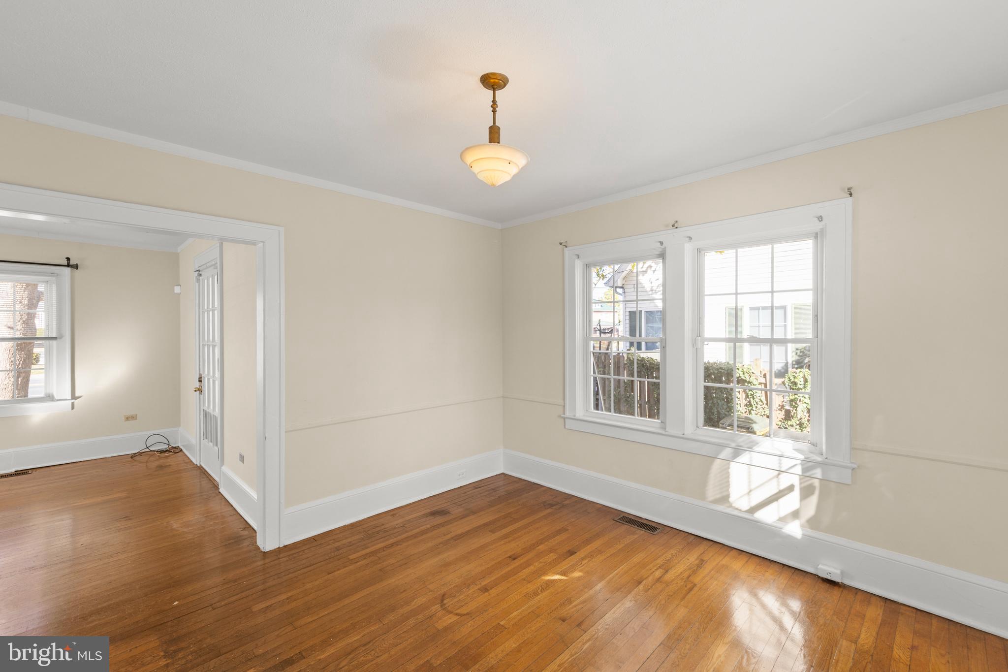 675 Berryville Avenue Winchester, VA 22601 - Photo 7 of 32 a view of an empty room with wooden floor and a window