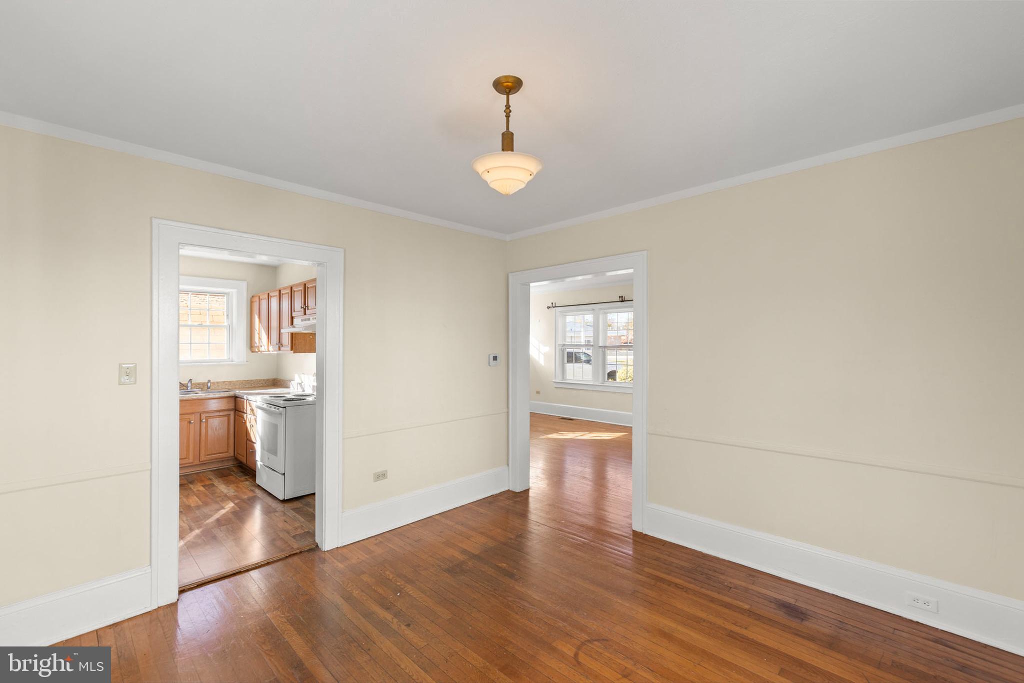 675 Berryville Avenue Winchester, VA 22601 - Photo 8 of 32 a view of an empty room with a window and wooden floor