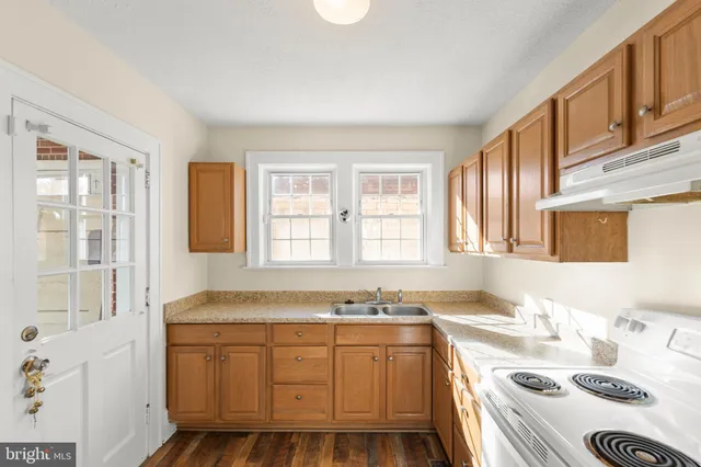 a bathroom with a granite countertop sink and a bathtub