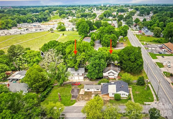 an aerial view of residential houses with outdoor space and swimming pool