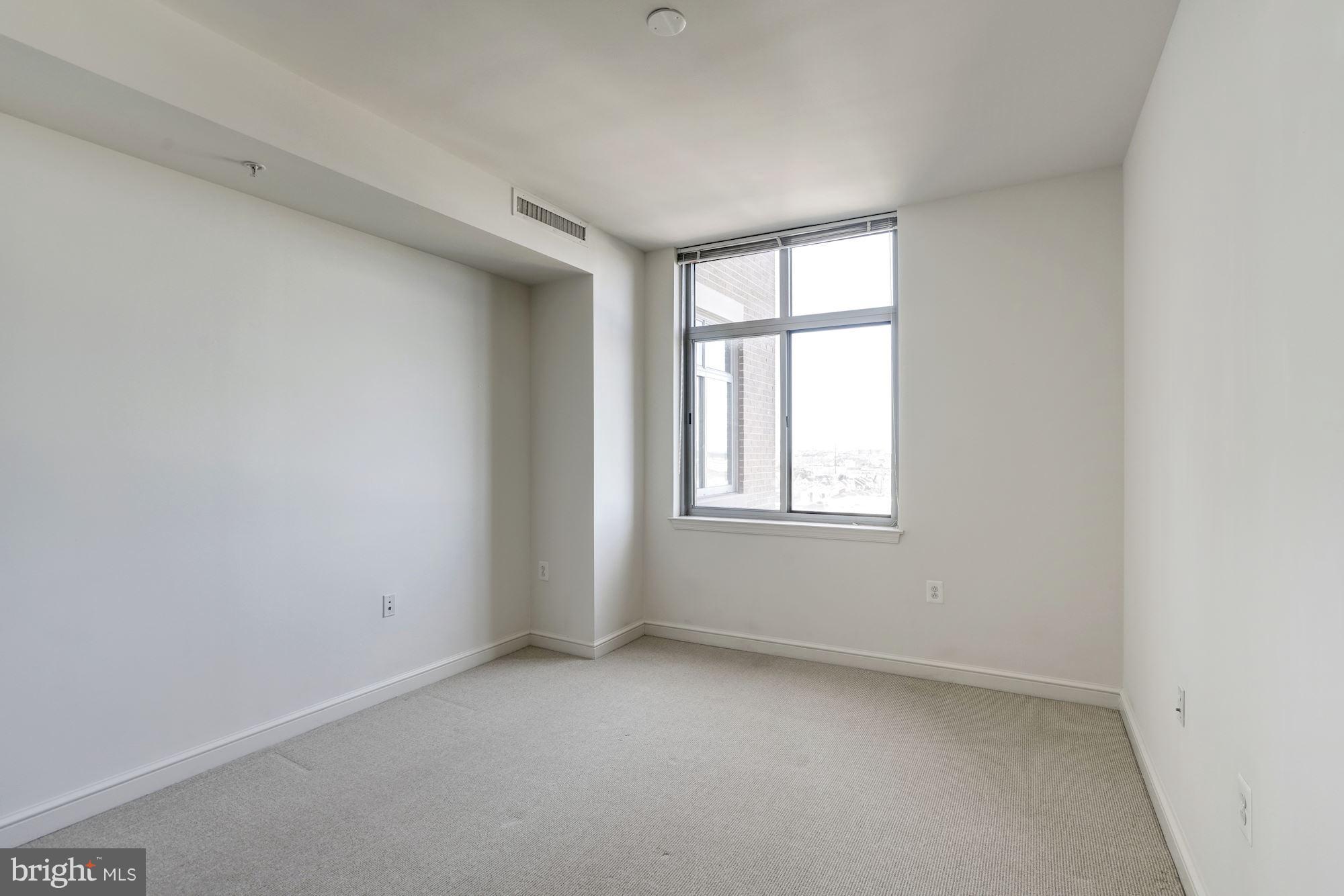 11990 Market Street, Unit 713 Reston, VA 20190 - Photo 18 of 30 an empty room with windows