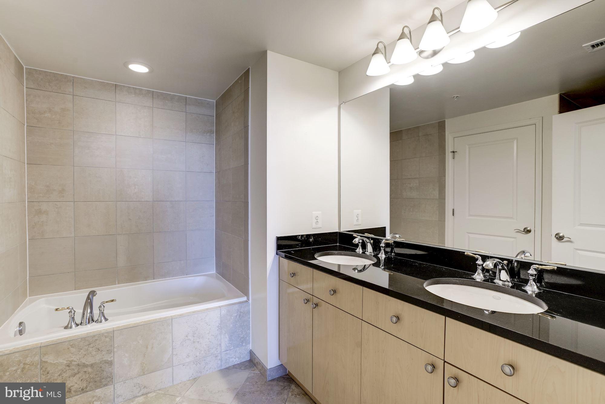 11990 Market Street, Unit 713 Reston, VA 20190 - Photo 19 of 30 a bath room with a sink and a mirror