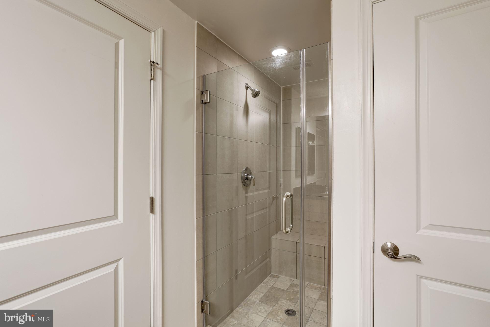 11990 Market Street, Unit 713 Reston, VA 20190 - Photo 20 of 30 a bathroom with a shower and a glass door