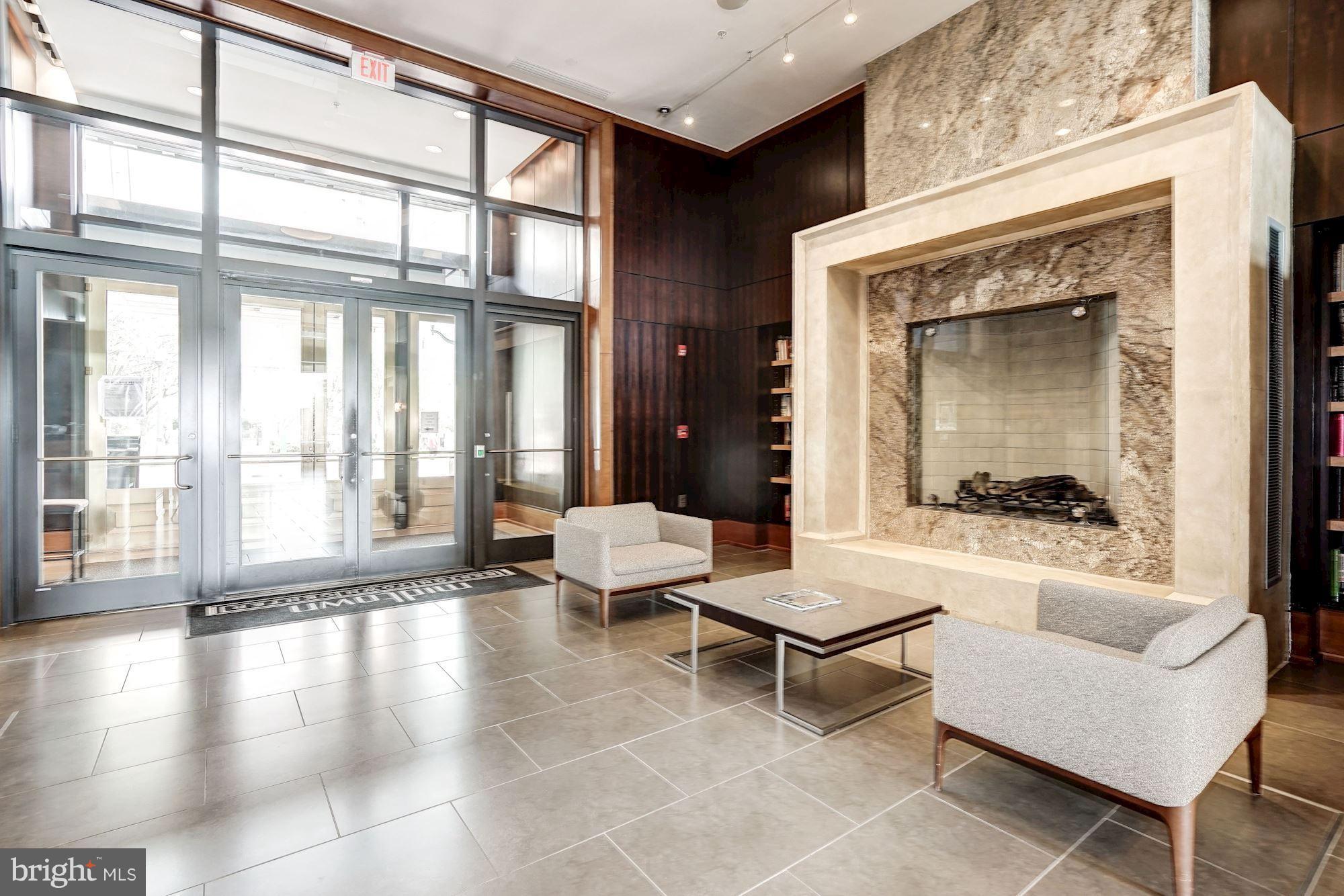 11990 Market Street, Unit 713 Reston, VA 20190 - Photo 4 of 30 a living room with furniture and a large window