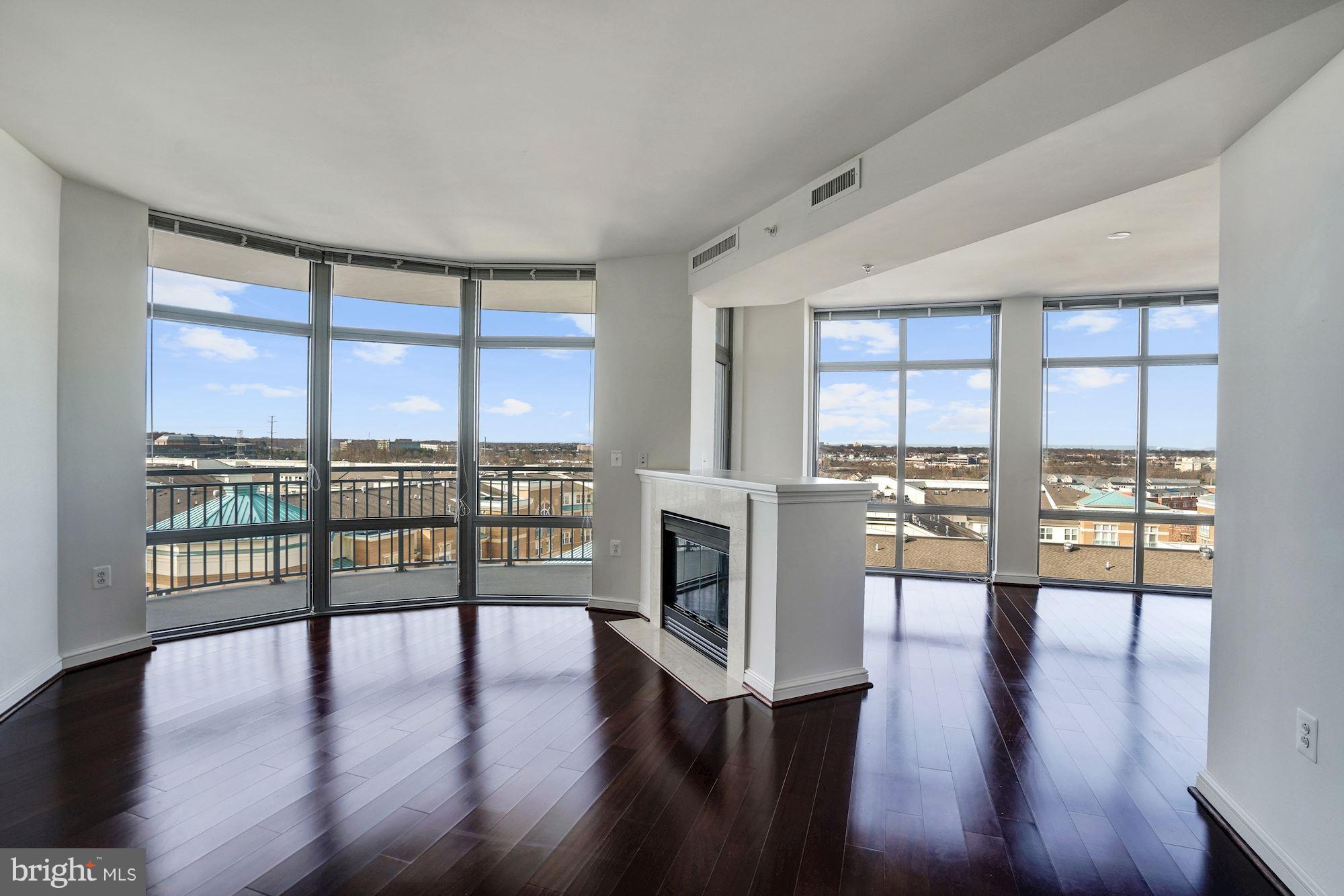 11990 Market Street, Unit 713 Reston, VA 20190 - Photo 7 of 30 a view of an empty room with wooden floor and a window