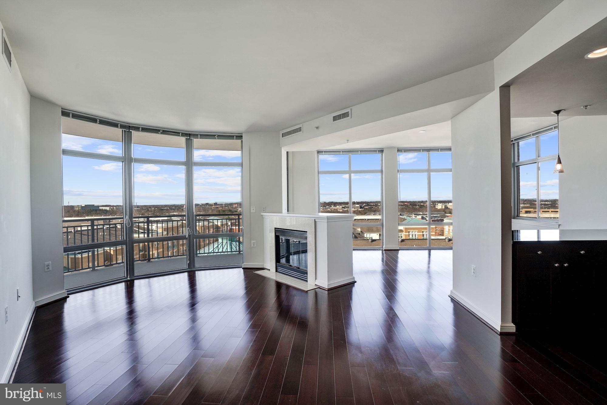 11990 Market Street, Unit 713 Reston, VA 20190 - Photo 8 of 30 a living room with stainless steel appliances wooden floor and a large window