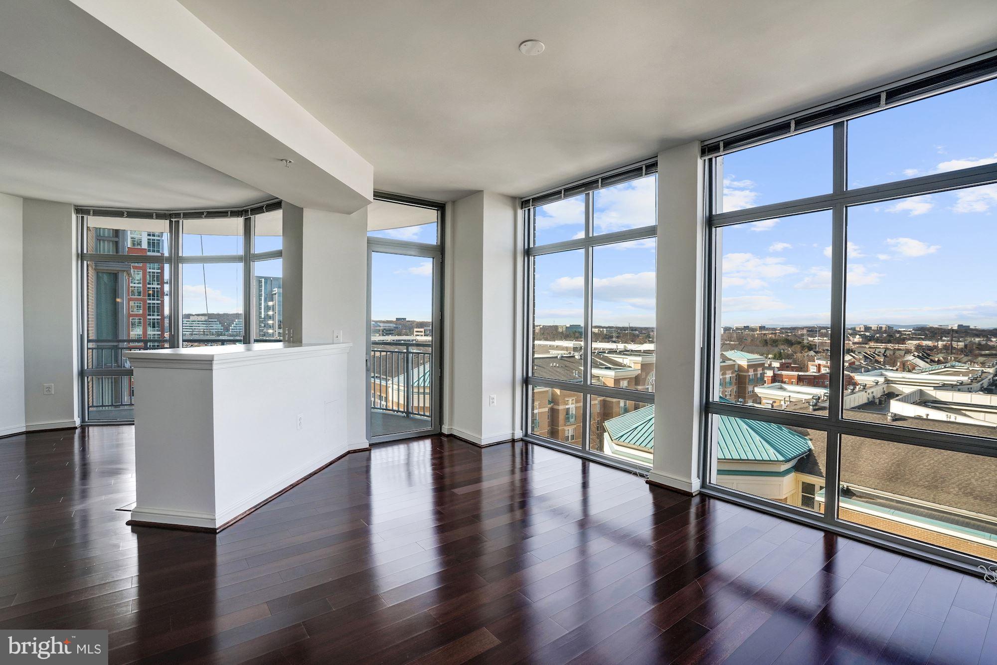 11990 Market Street, Unit 713 Reston, VA 20190 - Photo 9 of 30 a living room with a large window with outer view