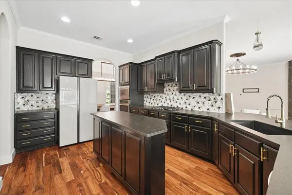 a kitchen with stainless steel appliances granite countertop a sink stove and microwave
