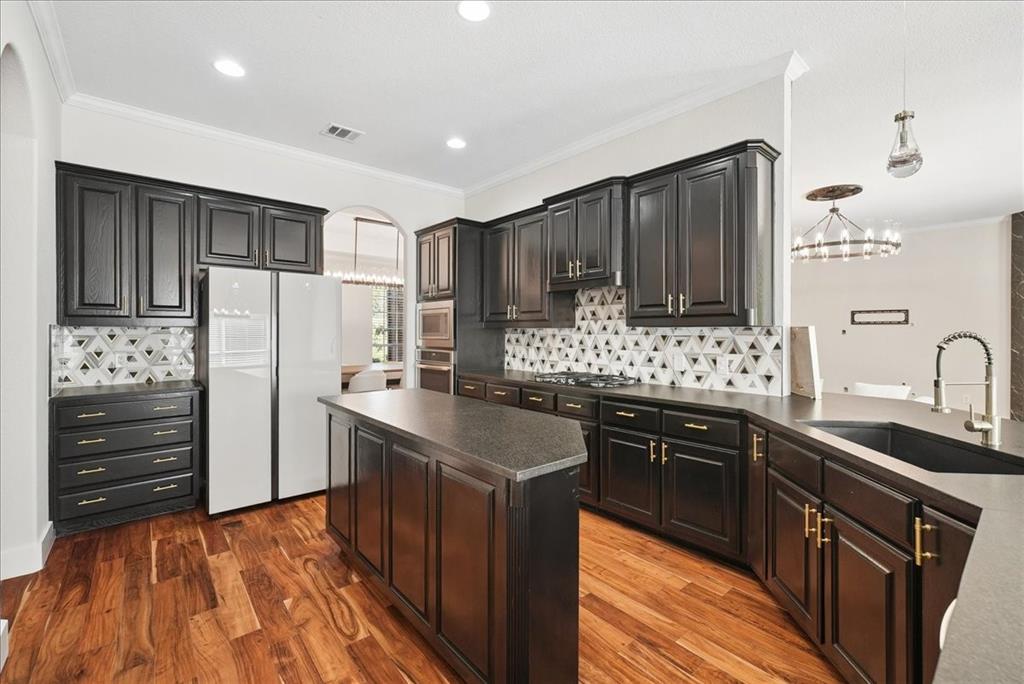 101 Deer Crossing Way Azle, TX 76020 - Photo 16 of 40 a kitchen with stainless steel appliances granite countertop a sink stove and refrigerator