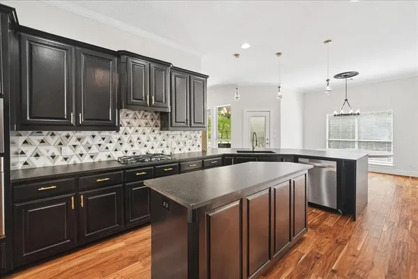 a kitchen with sink cabinets and wooden floor