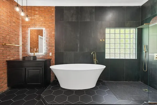 a bathroom with a granite countertop sink a toilet and shower