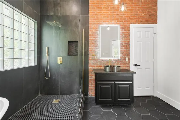 a bathroom with a bathtub and a shower