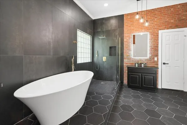 a bathroom with a granite countertop sink a toilet and shower