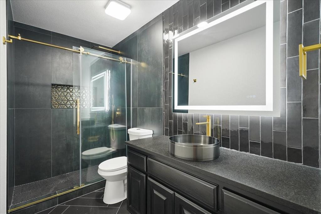 101 Deer Crossing Way Azle, TX 76020 - Photo 24 of 40 a bathroom with a granite countertop sink a toilet and shower