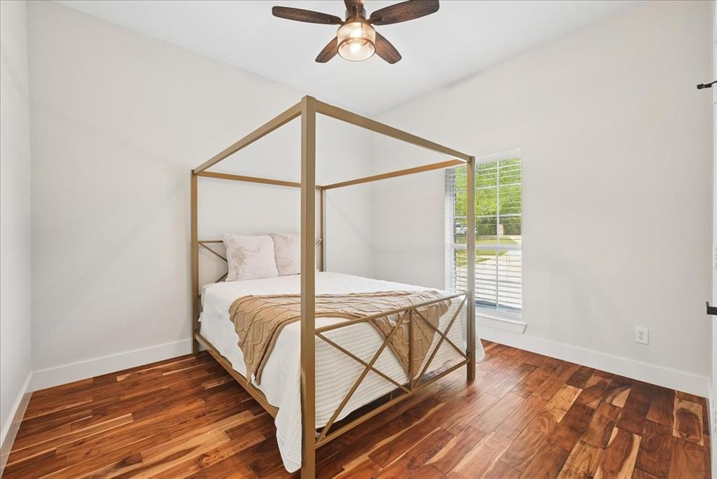 101 Deer Crossing Way Azle, TX 76020 - Photo 25 of 40 a bed sitting in a bedroom next to a window