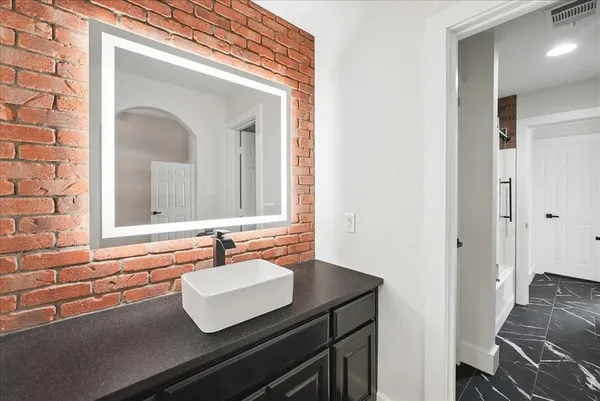a bathroom with a tub and a sink