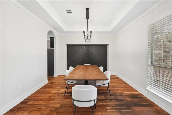 a view of an empty room with window and a ceiling fan