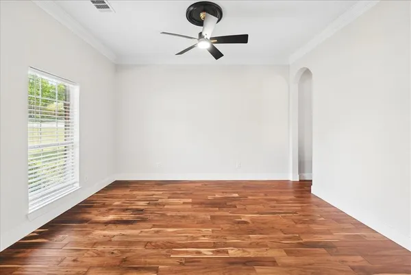 a view of workspace with wooden floor and ceiling fan