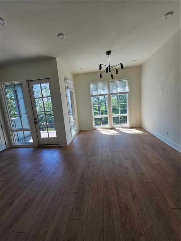 1294 Longreen Terrace Northwest, Unit 2 Atlanta, GA 30318 - Photo 9 of 25 wooden floor in an empty room with a window